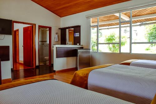 Postel nebo postele na pokoji v ubytování Hotel Villa Vianney