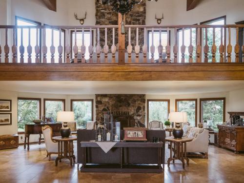 an open living room with a staircase with windows at Enzian Inn in Leavenworth