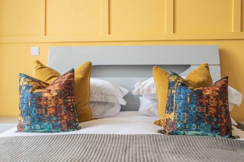 a white bed with pillows and a white headboard at The Pocklington - The Bradgate Suite in Leicester