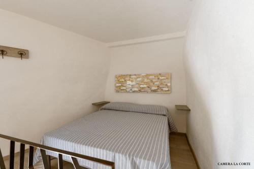 a small bedroom with a bed in a room at Casa Mimina in Ischia