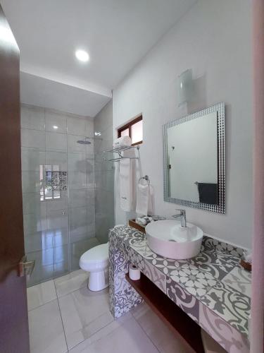 a bathroom with a sink and a toilet and a shower at Casa Allende Morelia in Morelia