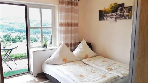 a small bedroom with a bed and a window at Appartement-Harlachberg-Blick-2 in Bodenmais