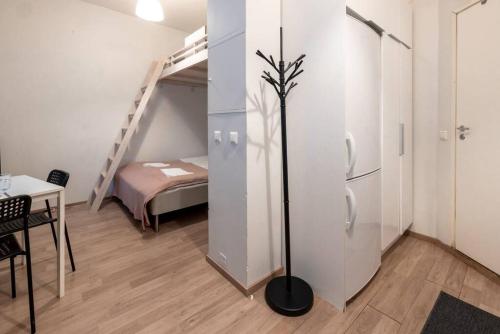 a room with a refrigerator and a room with a bed at 2ndhomes Kamppi Apartments 3 in Helsinki