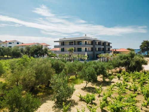 a building in the middle of a field of plants at Hotel Crystal in Orebić