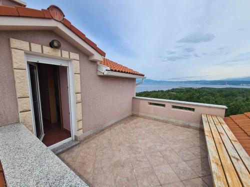 a balcony of a house with a patio at Apartman Nika in Omišalj