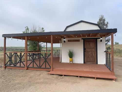 a building with a porch and a door on it at Modern wine country barn house in Temecula