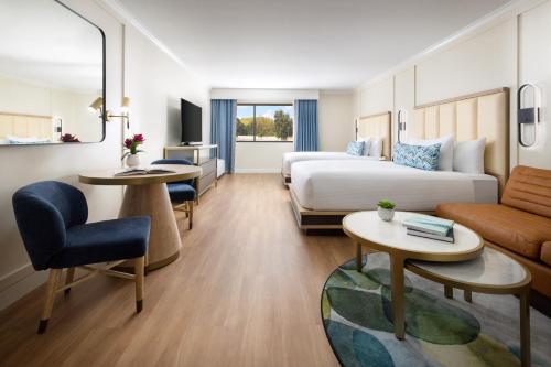 a hotel room with a bed and a living room at The Anza-a Calabasas Hotel in Calabasas