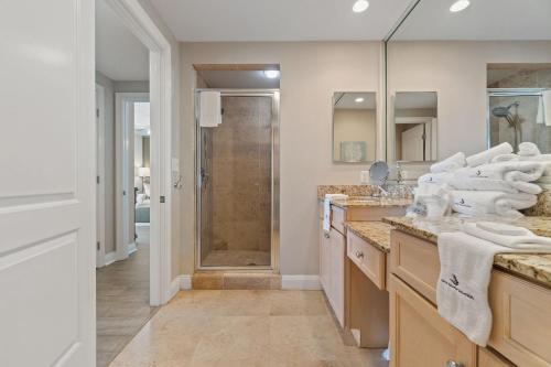 a bathroom with a shower and a sink with towels at Indigo East 1004 in Perdido Key