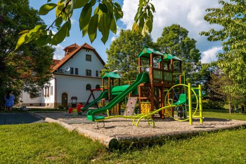 a playground with a slide in a park at Conacul Secuiesc-Székelykő Kúria in Colţeşti