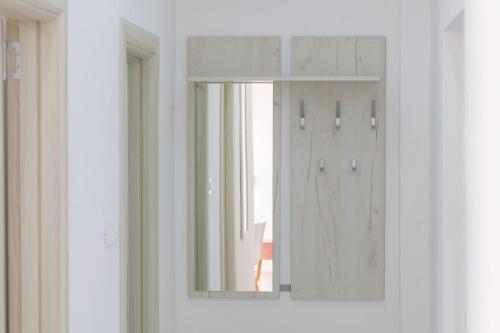 a mirror on the door of a room at Djukic Apartmani in Tivat