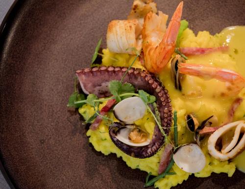 a plate of food with seafood and vegetables on it at Hotel Crystal in Orebić