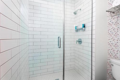 a shower with a glass door in a bathroom at Aloft Jacksonville Airport in Jacksonville