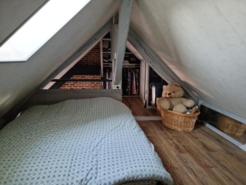 a bedroom with a bed and teddy bears in a tent at Appartement atypique climatisé in Semur-en-Auxois