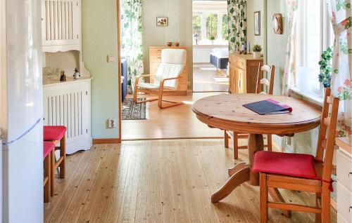 a kitchen and dining room with a table and chairs at 1 Bedroom Stunning Home In hus in Åhus