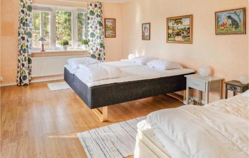 a bedroom with two beds and a window at 1 Bedroom Stunning Home In hus in Åhus