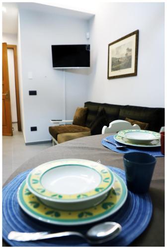 a table with plates and utensils on top of it at CASA DIDYMA in San Giovanni Gemini