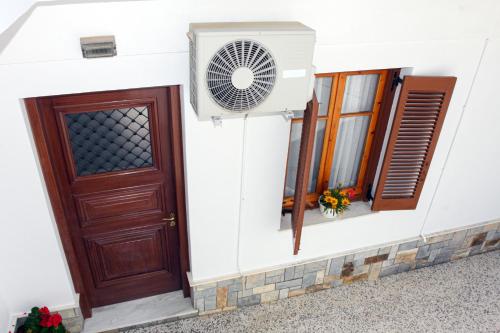 a house with a door and a fan at Anna's House in Glóssa