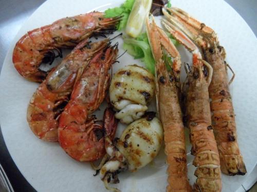 a white plate of food with shrimp and vegetables at Locanda Gallo in Dolo