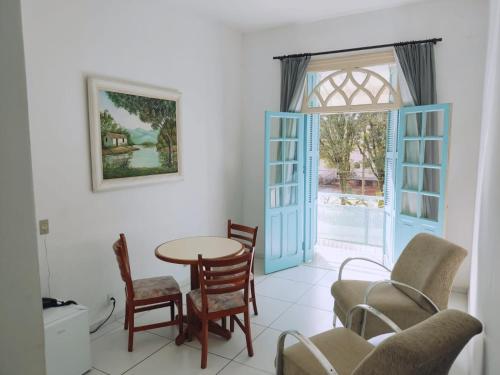 a dining room with a table and chairs at Grande Hotel Bragança in Bragança Paulista