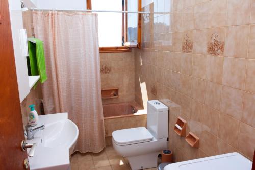 a bathroom with a toilet and a sink and a shower at Anna's House in Glóssa