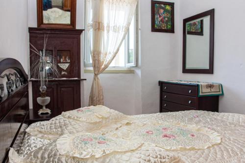 a bedroom with a bed and a dresser and a window at Anna's House in Glóssa