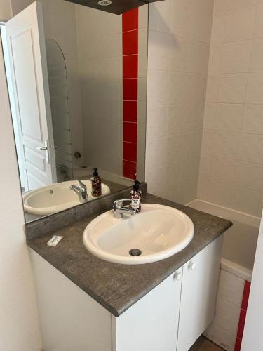 un comptoir de salle de bain avec un lavabo et un miroir dans l'établissement Studio residence de tourisme le Fonserane, à Béziers