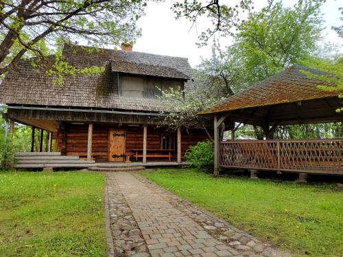 a log cabin with a pathway in front of it at Provinces Idille in Gulbene