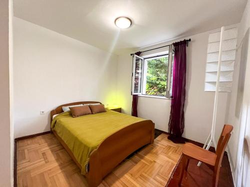 a bedroom with a bed and a window at Lamada Family Two Bedroom Apartment in Budva