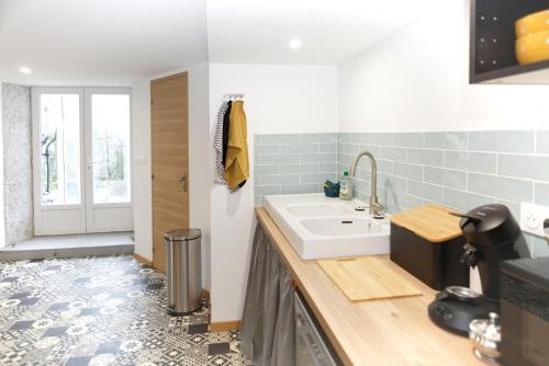 a bathroom with a sink and a counter top at Le Gîte des Cimes in Tulle