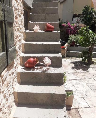 a toy bird sitting on the steps of a house at Christi Iuxury Apartment in Preveza