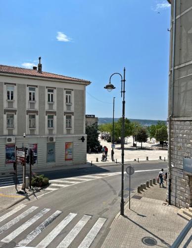 an empty street with a building and a street light at Villa Olivetta heritage residence in Crikvenica