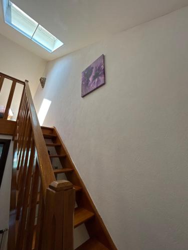 a stairway with a painting on the wall and a stair case at Hotel Halleux in Banneux