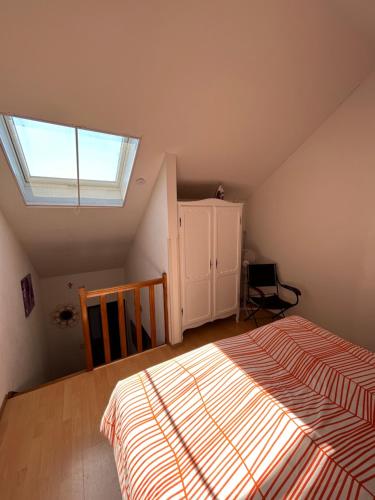 a attic bedroom with a bed and a window at Hotel Halleux in Banneux