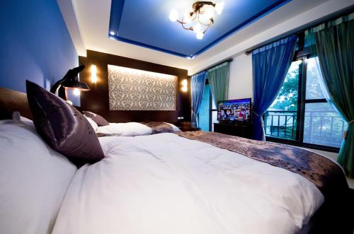 花蓮市的住宿－花蓮悠然自得，卧室配有一张白色大床和电视。