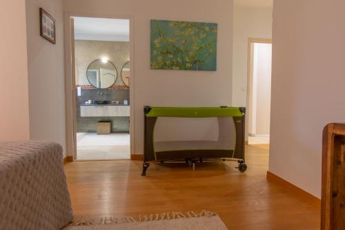 a bedroom with a green chair in a room at Villa Aixela 220m2 - 4ch - Piscine & Jardin 3000m2 in Fayence