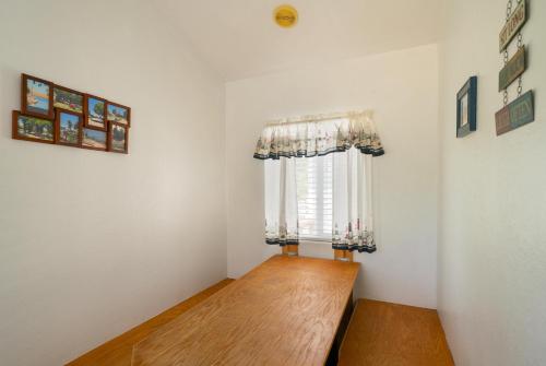 a small room with a window and a wooden floor at Snug Harbor RV Park & Marina in Walnut Grove