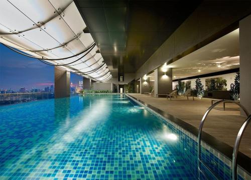 a large swimming pool in a building with a view at Duplex M-City ampang klcc by Mint in Kuala Lumpur