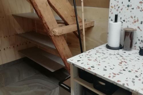 a staircase in a room with a counter and a table at Dreve 14 - bovenverdieping in Staden