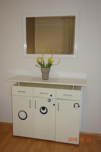 a white sink with a vase on top of it at Apartman Stella in Fažana