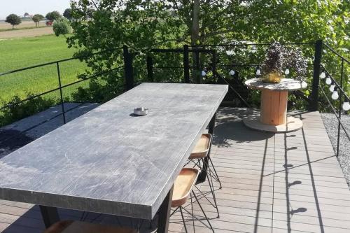 a table and two chairs on a wooden deck at Dreve 14 - bovenverdieping in Staden