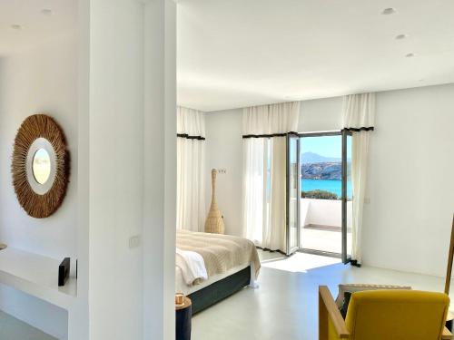a bedroom with a bed and a view of the ocean at Amalthea, Outstanding Seaside Luxury Villa, Paros in Santa Marina