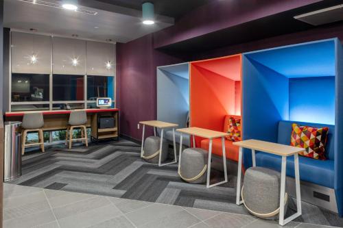 a colorful waiting room with tables and stools at Tru By Hilton Manteca in Manteca