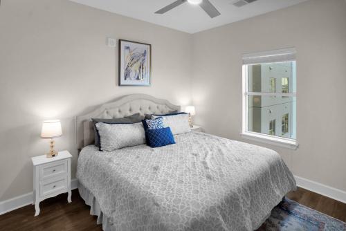 a bedroom with a bed with blue pillows and a window at Palatial Abode Nashville With Downtown View & Free Parking in Nashville