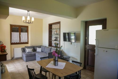 a kitchen and living room with a table and a refrigerator at Picturesque Houses in Leonidio