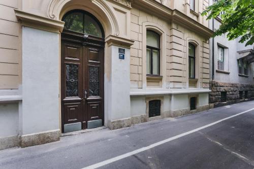 a building with a large wooden door on a street at Mika Apartment and Studios in Zagreb