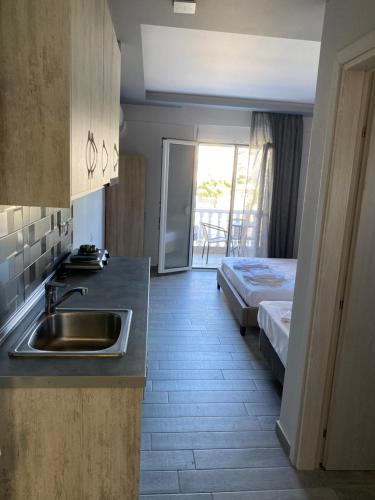 a kitchen with a sink and a bed in a room at Vila Savic in Olympic Beach