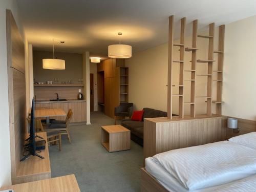 Un dormitorio con una cama y una sala de estar. en Apartment Pinia, en Starý Smokovec