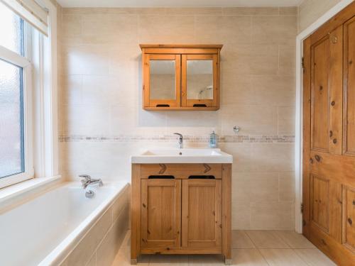 a bathroom with a sink and a bath tub at Cosy 2 bedroom house in the heart of Morpeth in Morpeth