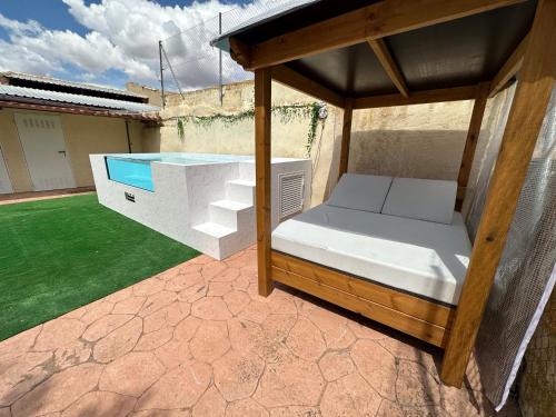 a bed under a canopy on a patio at Casa rural cerca Tarancón-Cuenca in Saelices