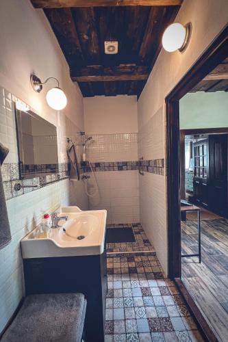a bathroom with a sink and a mirror at Padláskincsek Vendégház in Nagybörzsöny